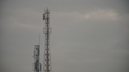 Transmitter tower with cloudy sky background