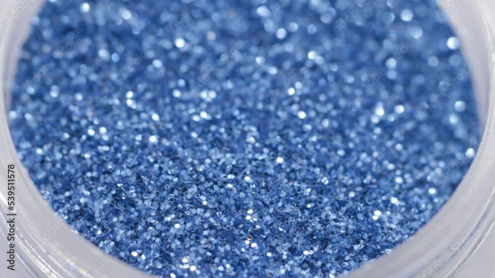 Poster blue sequins in a jar rotate in a circle
