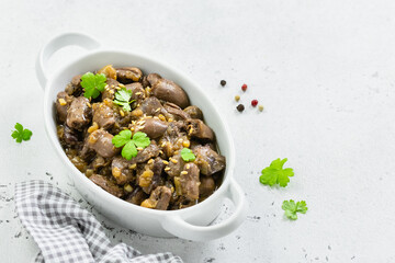 Spicy asian chicken hearts with parsley, onions, say sauce, sesame seeds. Top view, copy space,...