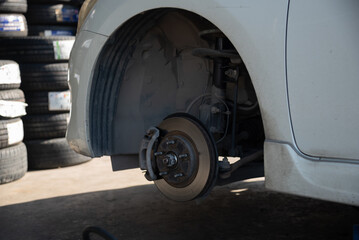 Change a car tire caused by a flat tire by using a jack to lift the car.