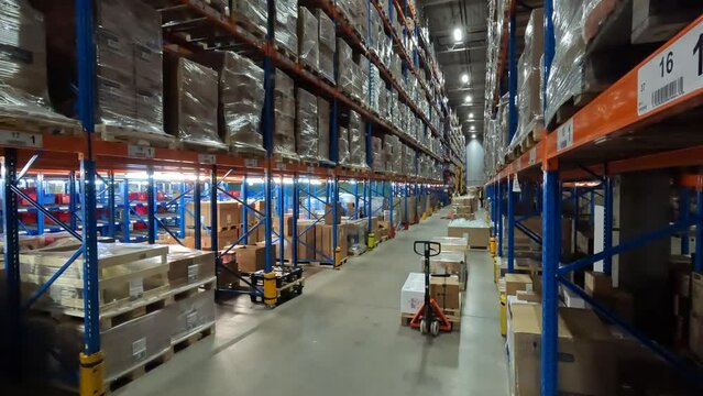 People work in a warehouse timelapse. Work with a modern warehouse. Workers move cardboard boxes in a warehouse