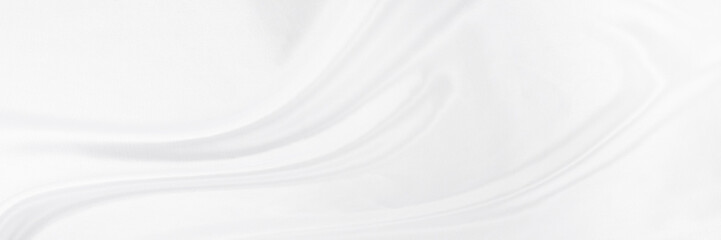White gray satin texture that is white silver fabric silk panorama background with beautiful soft blur pattern natural.