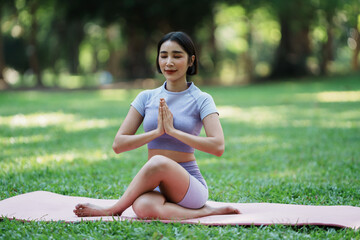 Fototapeta premium Beautiful young asian woman yoga exercising in the park.