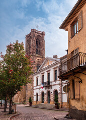 Fototapeta na wymiar Rouffach, France - October 11, 2022: Rouffach is a medieval town along the wine route in southern Alsace, France. View of the town hall and the Church of the Assumption of Mary