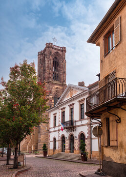 Rouffach, France - October 11, 2022: Rouffach is a medieval town along the wine route in southern Alsace, France. View of the town hall and the Church of the Assumption of Mary