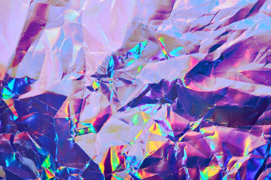 Iridescent Holographic Textural Background. Wrinkled Folded Paper Or Foil With Iridescent Highlights