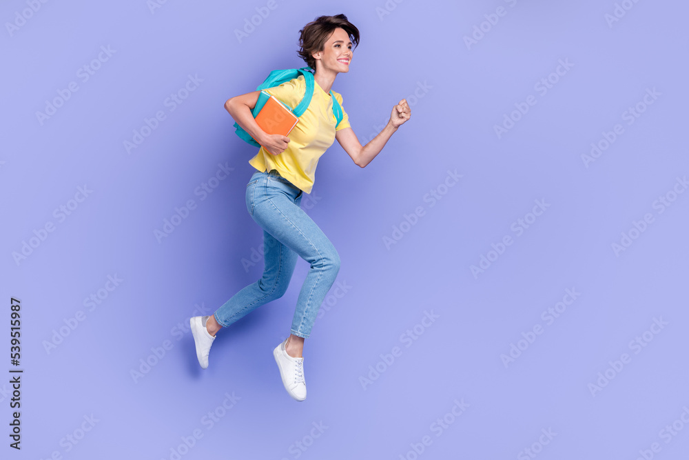 Sticker Full length portrait of carefree active person carry bag hold book jump rush isolated on purple color background