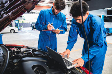 Mechanic checking the parked engine with computer.