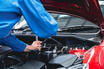 Mechanics doing car service and maintenance.