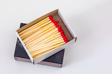 Wooden matches with red heads and matchboxes