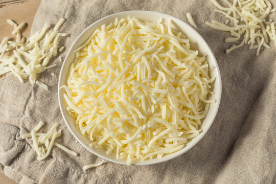 Shredded Mozzarella Cheese in a Plastic Container Stock Photo