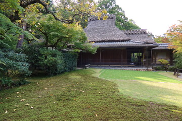 A Japanese traditional house with a thatched roof in Yoshiki-en Japanese Garden in Nara City in Nara Prefecture in Japan 日本の奈良県奈良市にある吉城園の日本伝統的茅葺き家屋