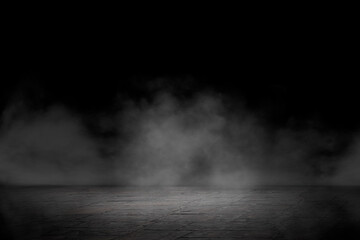 Concrete floor with smoke or fog in dark room with spotlight. Asphalt night street. Mist on black...