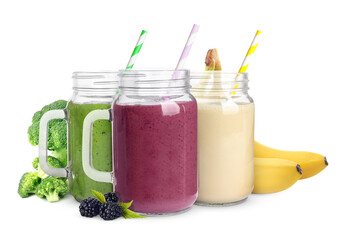 Different delicious smoothies in mason jars on white background