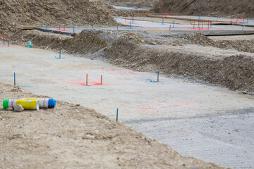 On site: Working at the basement - installation of underground infrastructure - different color...