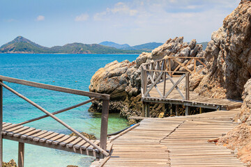 wood boardwalk with background  is mountain and blue sky