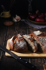 A loaf of rye bread in low key	