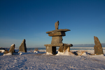 Inukshuk or Inuksuk found near Churchill, Manitoba with snow on the ground in early November,...