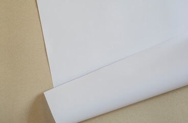 A sheet of white paper on a brown background.