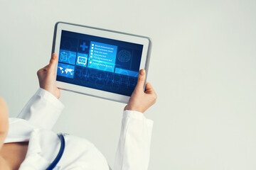 Close of female doctor hands working with tablet pc computer