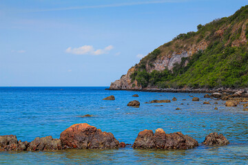 Coast and rock with background  is mountain and blue sky