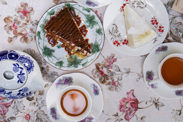 Afternoon tea with chocolate cake and coconut cake on the table