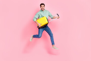 Full length photo of cheerful boy wear stylish clothes hold baggage rejoice summer holiday abroad isolated on pink color background