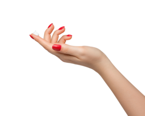 A drop of thick white hand cream on the finger of a woman's hand. Groomed hands, natural short nails with red nail polish.