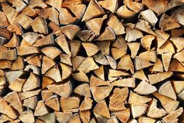 Background, texture stacked dry chopped firewood