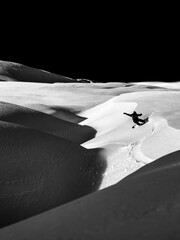 Breathtaking vertical shot of a snowboarder on the snowy hillside