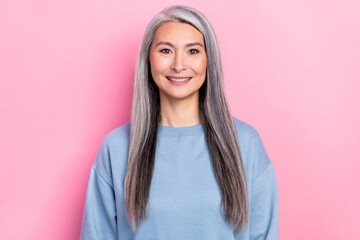 Fototapeta premium Photo of adorable charming retired woman blue sweater smiling isolated pink color background