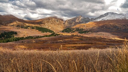 Landscape of rock formations with trees in the foreground on a cloudy day