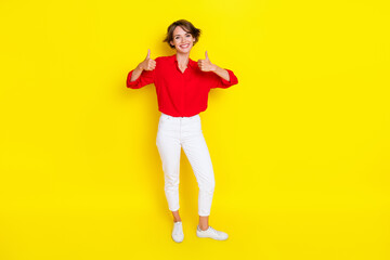 Fototapeta na wymiar Full length portrait of cheerful charming person hands fingers demonstrate thumb up isolated on yellow color background