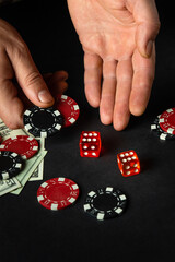 The player throws the dice on the table in the poker club. Luck or fortune in the casino