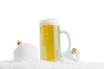 Mug of cold beer and two Christmas balls on the snow. Selective focus