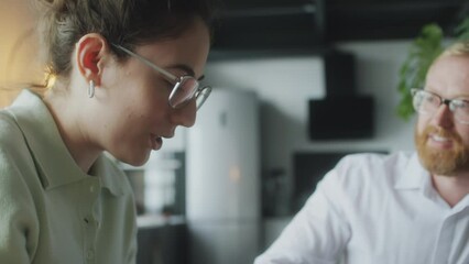 Financial planner speaking with young woman as she sighing agreement during consultation at home