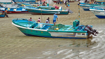 Fishing fleet on the beach in the harbor in Puerto Lopez, Ecuador