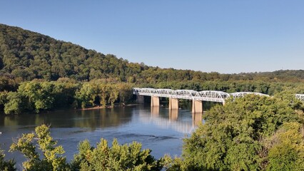 Natural landscape with Potomac river in beautiful early morning sunlight at Point of Rocks Maryland, Virginia border bridge crossing