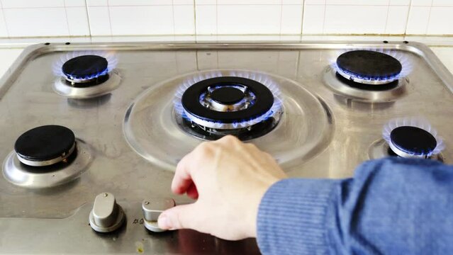 Gas cooker with burning flames of gas. Domestic kitchen with blue flames burning