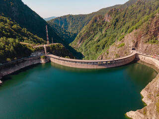 Aerial photography of Vidraru dam, in Romania. Photography was shot from a drone from above the Vidraru lake with the dam in the view.