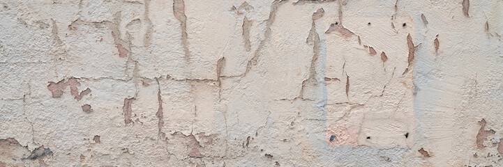 old plaster wall background and texture with holes and cracks and paint peeling off, panoramic web banner