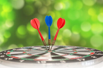 Fototapeta premium Playing darts with darts on a bokeh background. Competition and sport.
