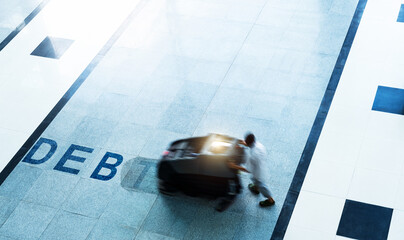 Top view of people sweeping the word debt on floor with machine © xy