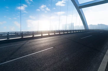 Fototapeten Empty asphalt highway bridge of city under blue sky © xy