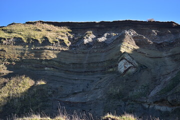 Nature background.  Soft focus of geological structure, landslide on steep coastal cliffs 