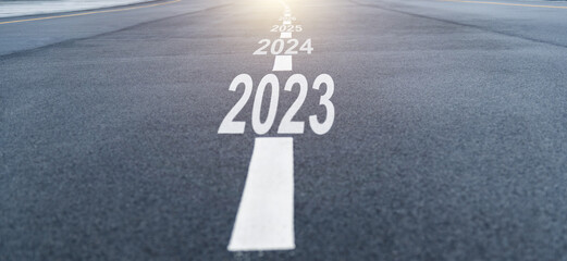 Black asphalt road with new year numbers 2023, 2024 to 2028 with white dividing lines