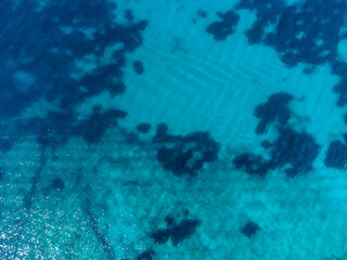 Fototapeta na wymiar Aerial drone view of transparent sea water at summer. Beautiful tropical sea surface, view from above. Sea waves.
