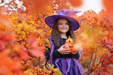 Fototapeta na wymiar Closeup portrait of a little Halloween witch
