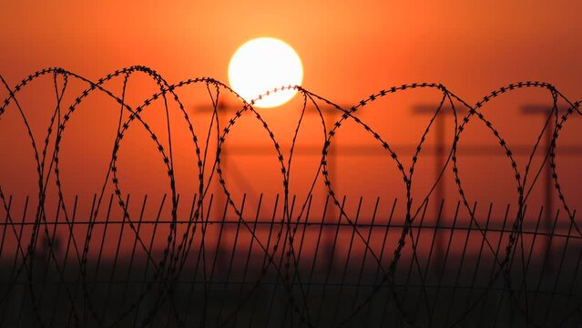 barbed wire fence at sunset, protected area