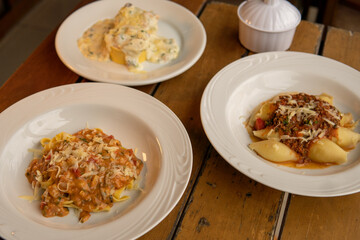 dishes with different italian pasta and types of sauce